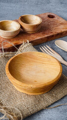Rustic Wooden Bowls and Utensils on Burlap A Simple Table Setting
