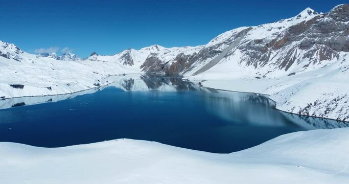 Drone shot of Blue Tilicho Lake. World's highest Lake at Manang Nepal covered with snow. Reflection of Annapurna Mountain in Lake gives the vibrant and Heavenly view. Himalayas calm and peace 4K