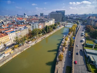 Photo sur Plexiglas Vienne Danube River in Vienna, Austria. Ferry, Cityscape in Background.