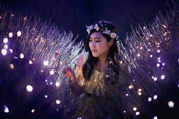 Portrait image of an asian woman in a beautiful lavender flower field