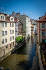 Fototapeta na wymiar between old historical houses in Prague runs the river Elbe