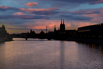Panoramic evening view on Wroclaw Old Town. Silhouette of Island and Cathedral of St John with bridge through river Odra. Wroclaw, Poland. Grunwaldzki bridge over the Odra river