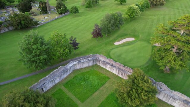 Backward drone over Desmond Castle near Maigue River in Adare, Ireland. Aerial