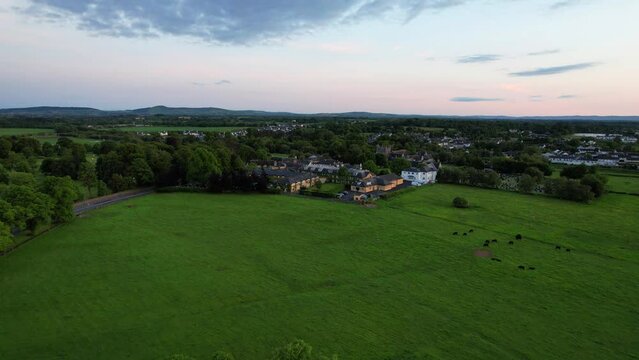 Backward aerial view over St Nicholas Church and Augustinian Friary in Adare, Ireland