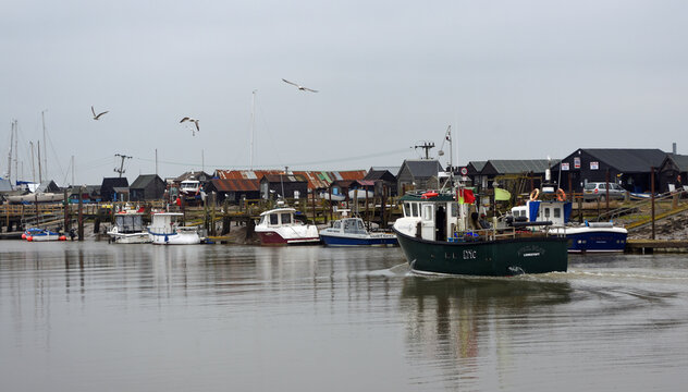 Fishing boat entering the river Blyth at Warbleswick Suffolk.