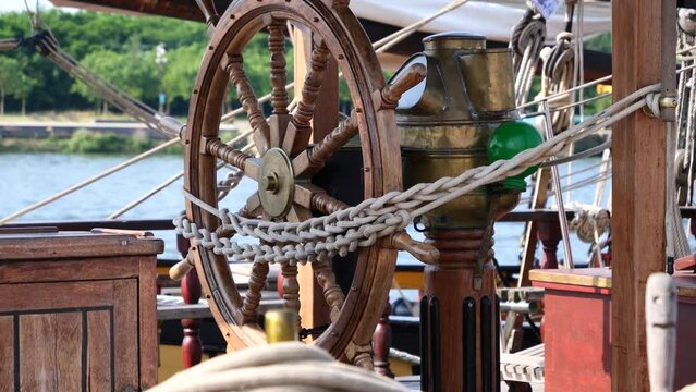 Closeup of a vintage hand wheel on wooden sailing boat. helm of old wooden sailboat
