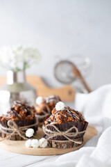 Still life with cakes covered with white icing and chocolate on the kitchen table