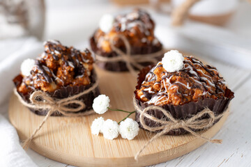 Still life with cakes covered with white icing and chocolate on the kitchen table