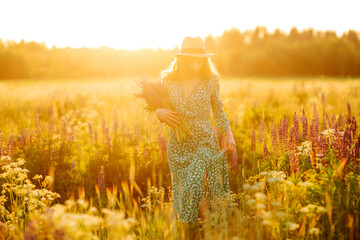 Young woman in lavender field on summer day. Nature, vacation, relax and lifestyle