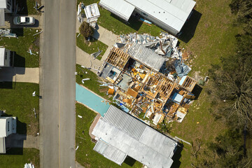 Severely damaged houses after hurricane Ian in Florida mobile home residential area. Consequences...