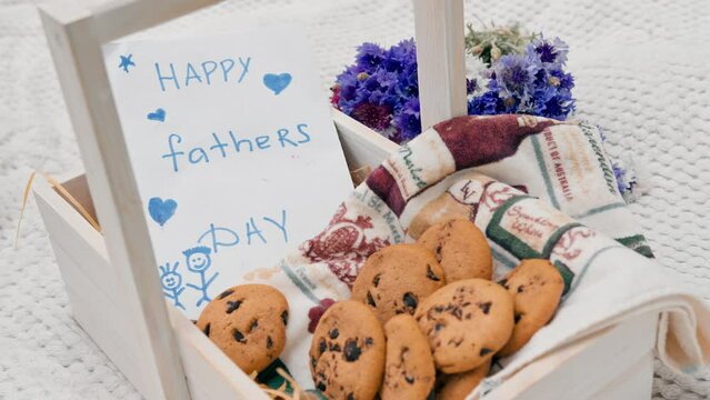 close-up painted father's day card and flowers with cookies family carefree childhood celebration