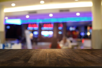 Empty wooden table in front of abstract blurred background of coffee shop . can be used for display or montage your products.Mock up for display of product.