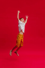 a boy jumps on a bright background