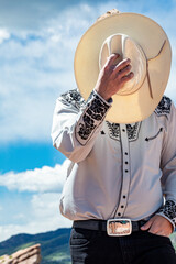 Cowboy putting on cowboy hat