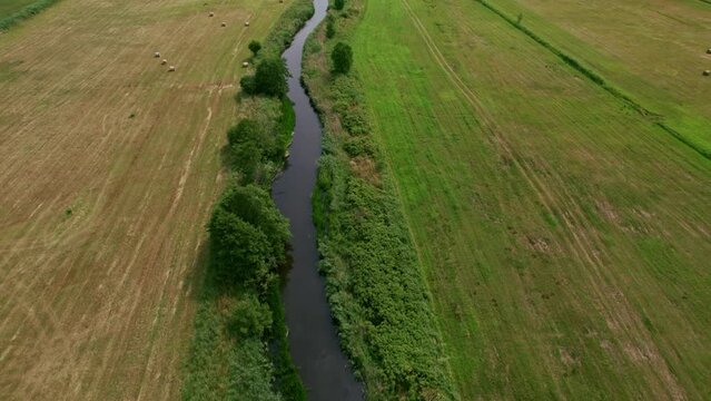 Flying over a river to reveal a seashore in Polish nature reserve "Beka".