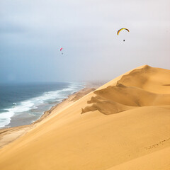 paragliding in the desert dunes near Walvis bay in Namibia