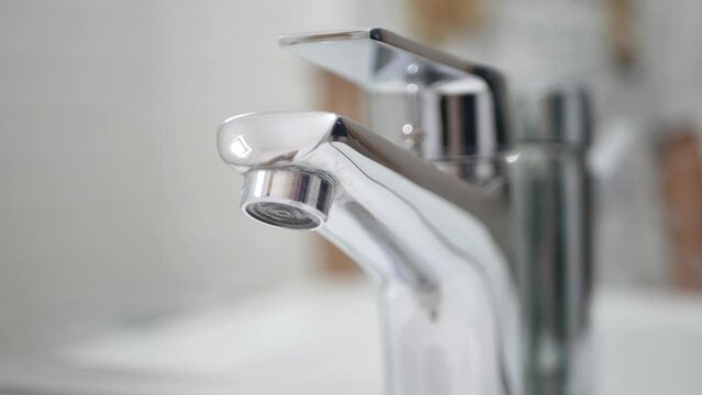 Hand Turn On Off the Tap Water on Sink, Faucet, Woman Stops Wasting Water, Inundation, Running Water for Washing in Bathroom