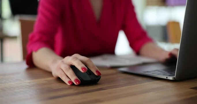 Business woman manually typing on computer keyboard using a mouse sitting at desk in office or working at home. Remote work teleworking or searching for information on network
