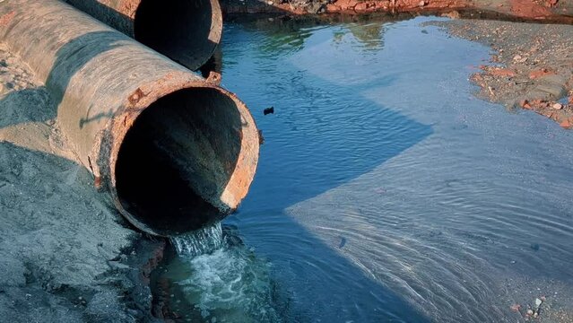 Large industrial pipes for dumping chemical waste into the river.