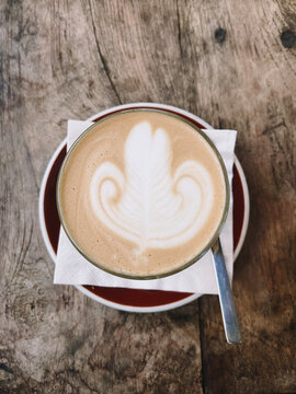 Glass of Caramel Latte with latte art with Wooden Background