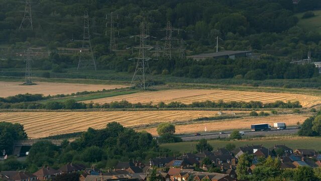 Rice field agriculture crop cultivation or harvest with tractor and truck machine and highway road for transportation from famous view point of Frodsham city, Cheshire, United Kingdom, UK