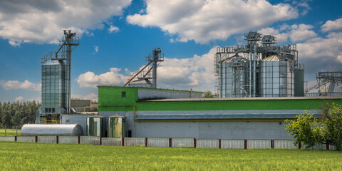 Obraz premium agro silos on agro-industrial complex and grain drying and seeds cleaning line.