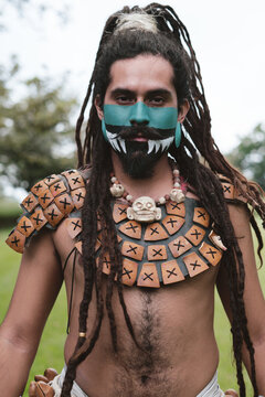 Native man with dreadlocks looking to the camera