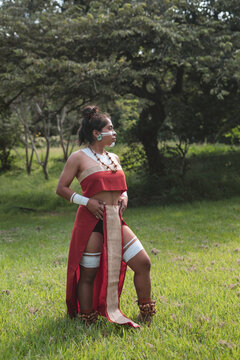 Native woman with red garments looking to the horizon
