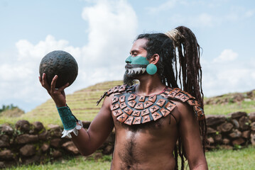 Mayan warrior looking at a rubber ball in pyramid background