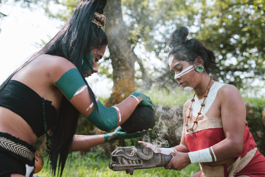 Young Mayan female warriors in traditional clothes doing ritual activities