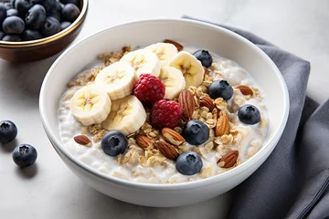 Tuinposter Oat porridge with banana, blueberry, walnut, chia seeds and almond milk for healthy breakfast or lunch.  © reddish