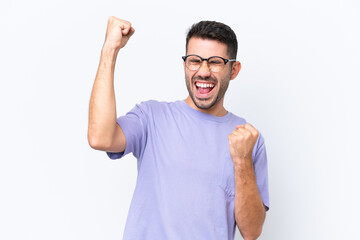 Fototapeta premium Young caucasian man isolated on white background celebrating a victory