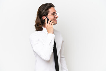 Fototapeta premium Business handsome man isolated on white background keeping a conversation with the mobile phone with someone