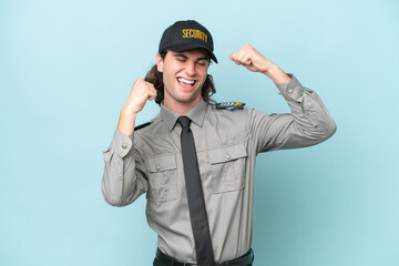 Young safeguard man isolated on blue background celebrating a victory