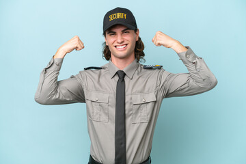 Young safeguard man isolated on blue background doing strong gesture