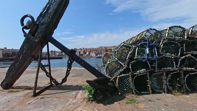 crab pots, lobster pots and fish traps on the historic grade 2 listed Tate Hill Pier in Whitby harbour on the North Yorkshire Coast. Captured on a bright and sunny summer day