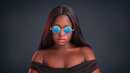 Woman portrait. Style. Handsome Cool Afro American girl in sun glasses is looking at camera and smiling.