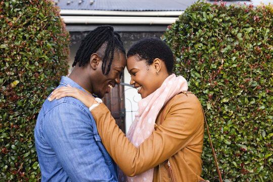 Side View Of Romantic African American Couple Looking At Each Other While Standing Outside House