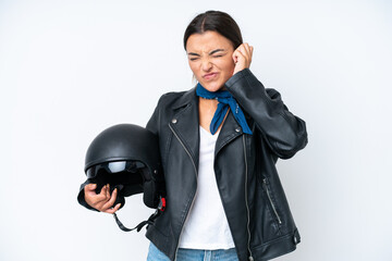 Young caucasian woman with a motorcycle helmet isolated on blue background frustrated and covering ears