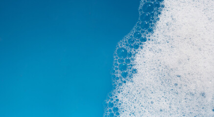 Detergent foam bubble on water. Blue background, Soap sud
