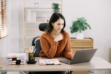 lifestyle of office workers Woman calculating expenses and using laptop. Home office. Work place....