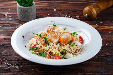 Lunch Caesar salad with salmon, parmesan cheese, quail eggs, lettuce, tomatoes and croutons.