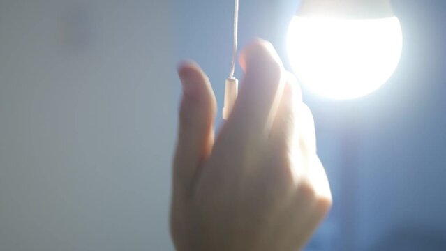 Turning the Light On a Led Bulb, Turn On the Light in a Dark Room, Girl Turns the Light On at Home, Pull Switch On Off