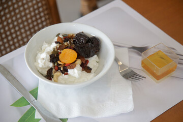 Greek yoghurt in bowl with honey, nuts, seeds and dried fruits, healthy breakfast diet