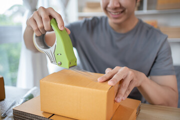 Fototapeta na wymiar Efficient Home-Based Delivery, Man Packing Items into Post Box for Customer Shipping, Online Shopping and Small Business Entrepreneurship, Packing box, Sell online, Freelance working.