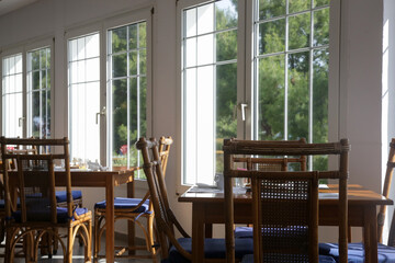 Empty seats and tables before dinner time in the indoor restaurant