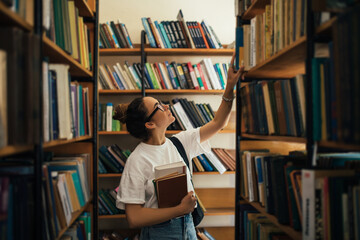 A student stuying and reading books in a public library.