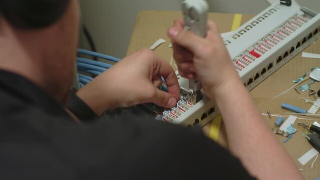 Connecting cables in patch panel with punch down tool