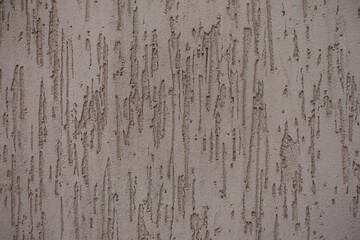 Close shot of dusty brown wall with stucco worm finish