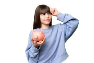 Little girl holding a piggybank over isolated chroma key background having doubts and with confuse face expression